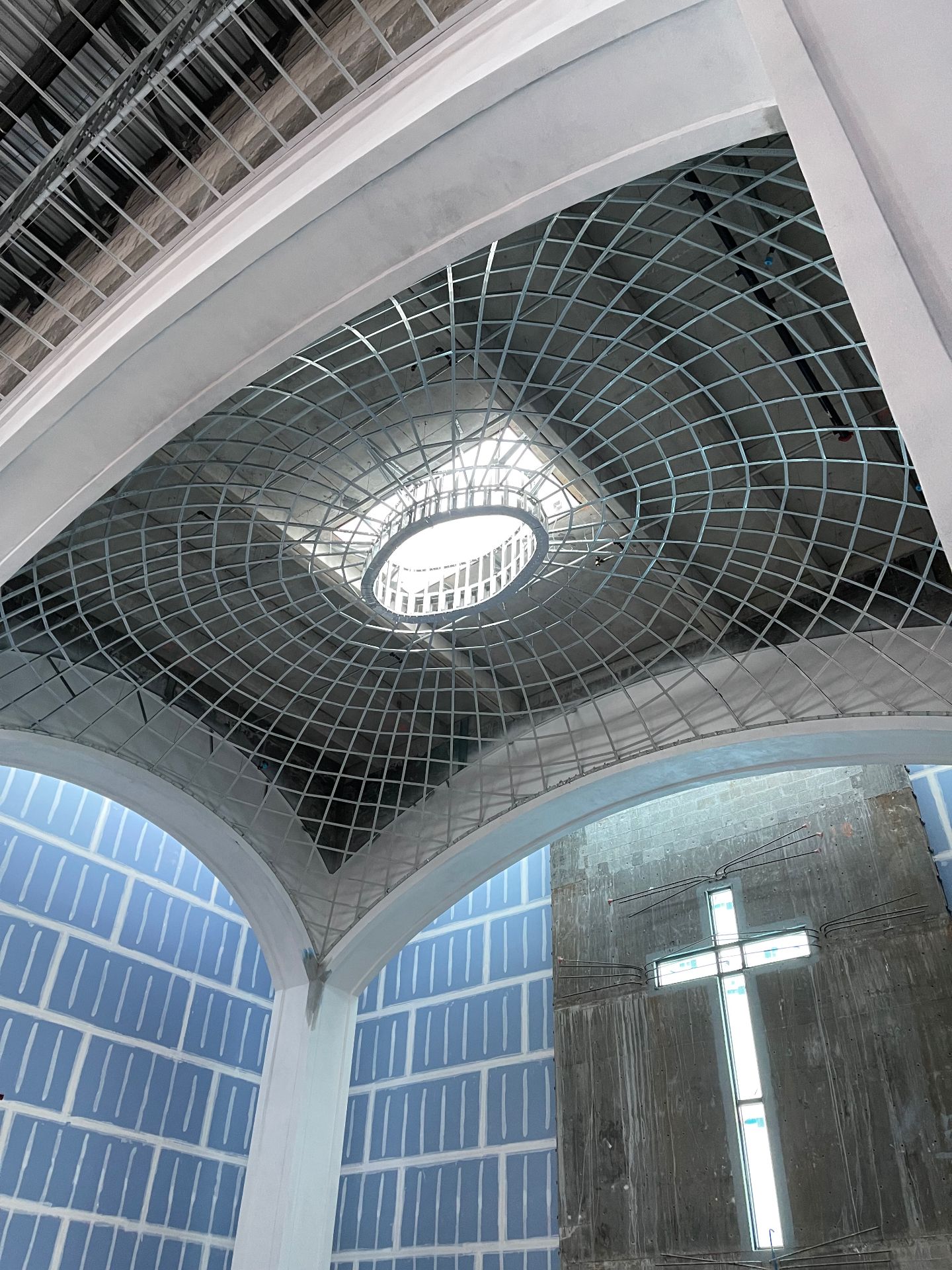 Curved architectural ceiling structure under construction